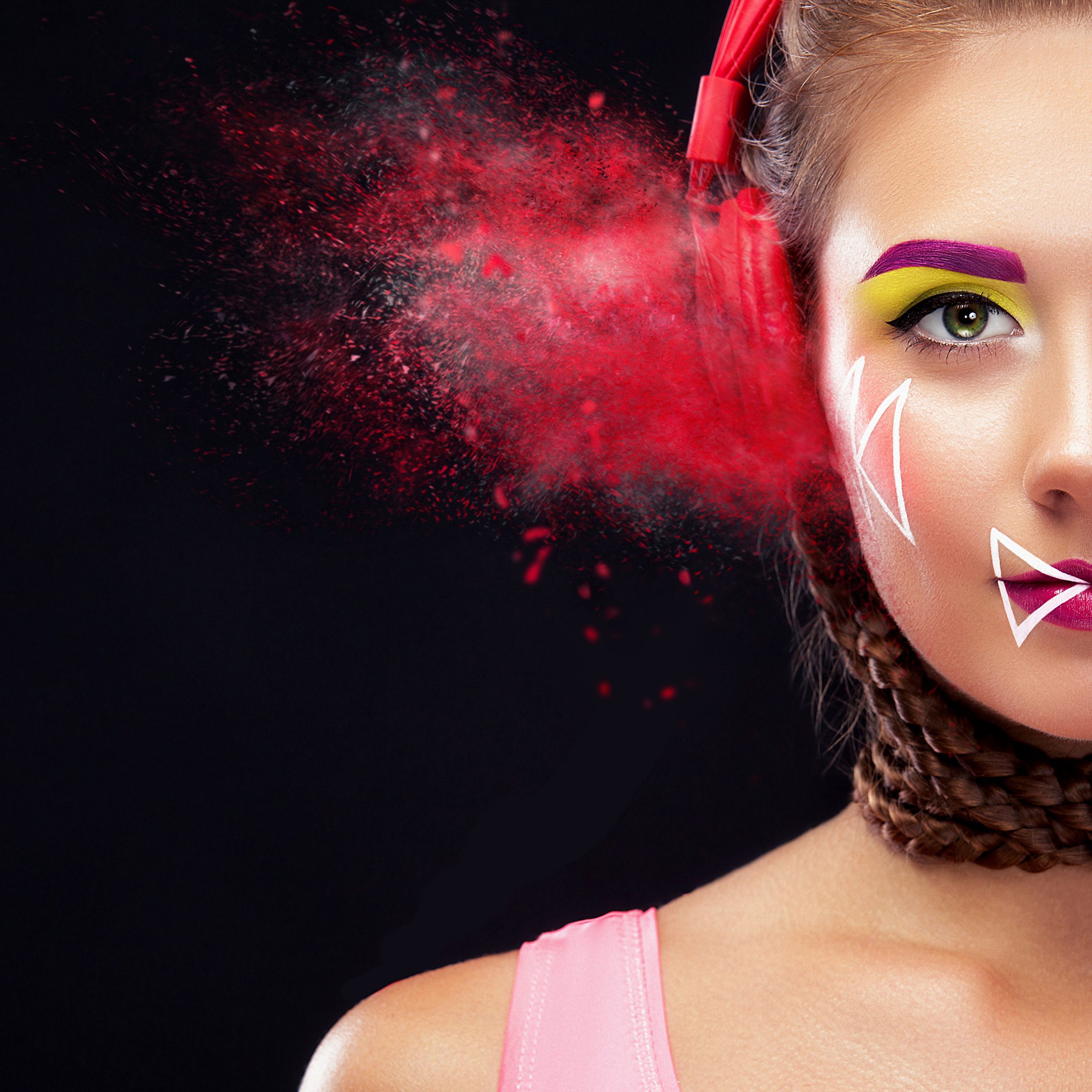 modern young woman with art makeup enjoys listening to music in headphones. positive emotions, leisure. creative maek up.